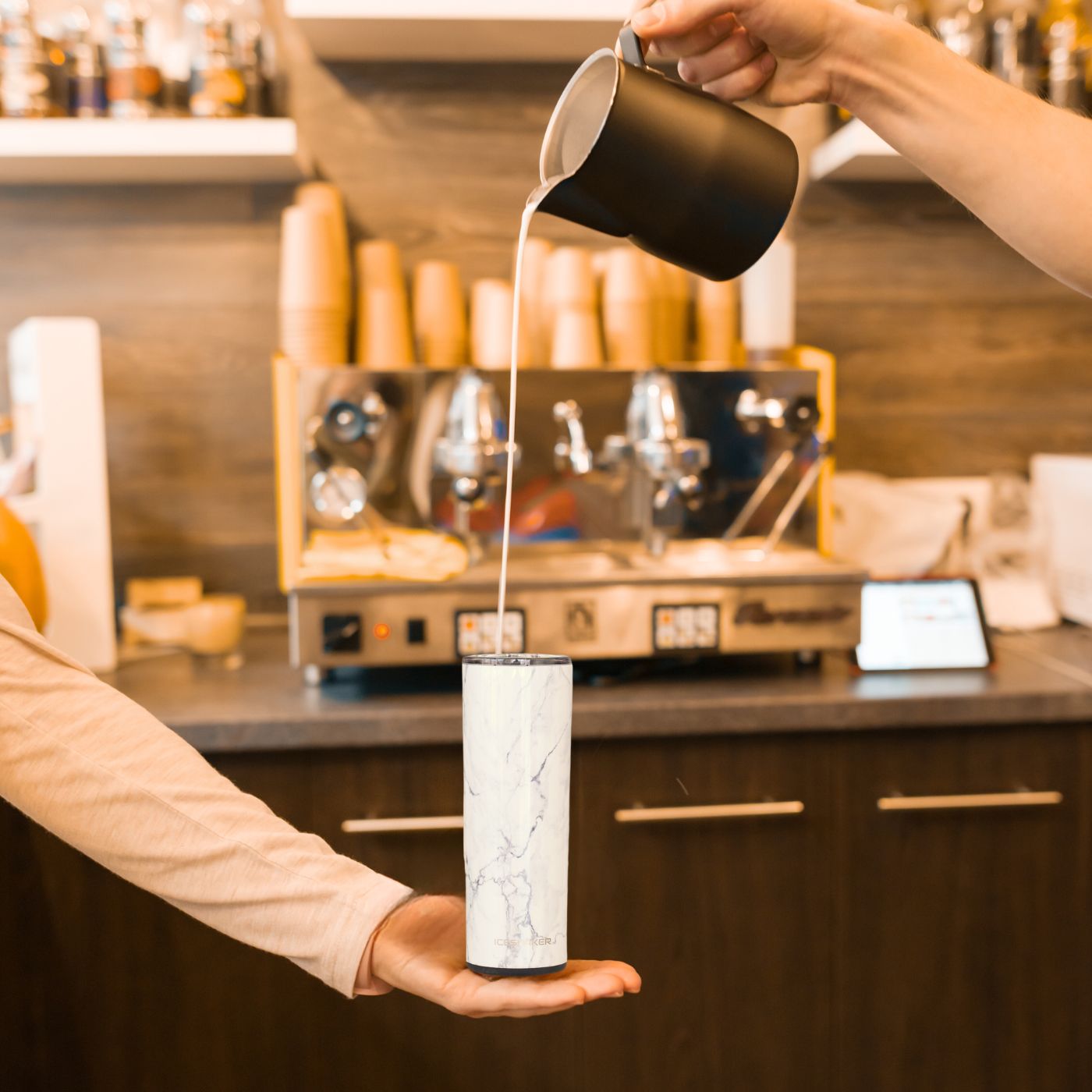 An image of hot coffee being poured into a White Marble 20oz Skinny Tumbler.