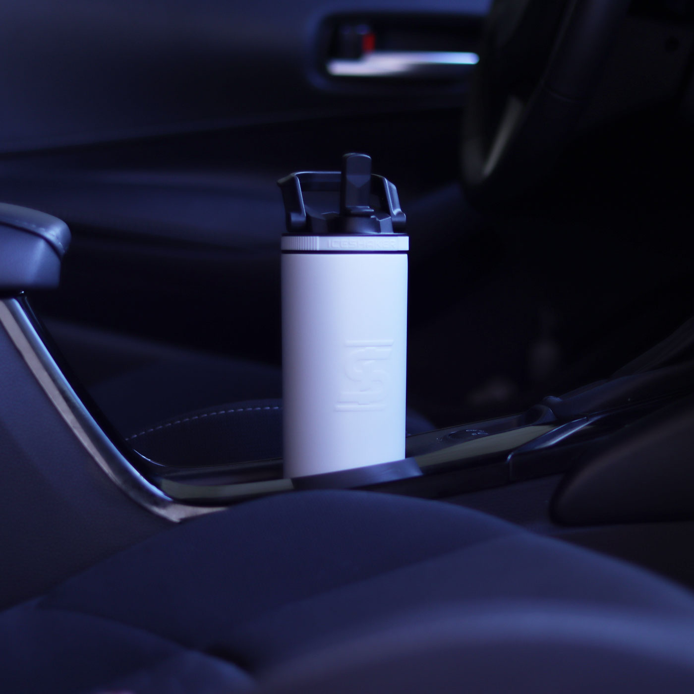 An image of the 20oz Sport Bottle fitting in a car cup holder.