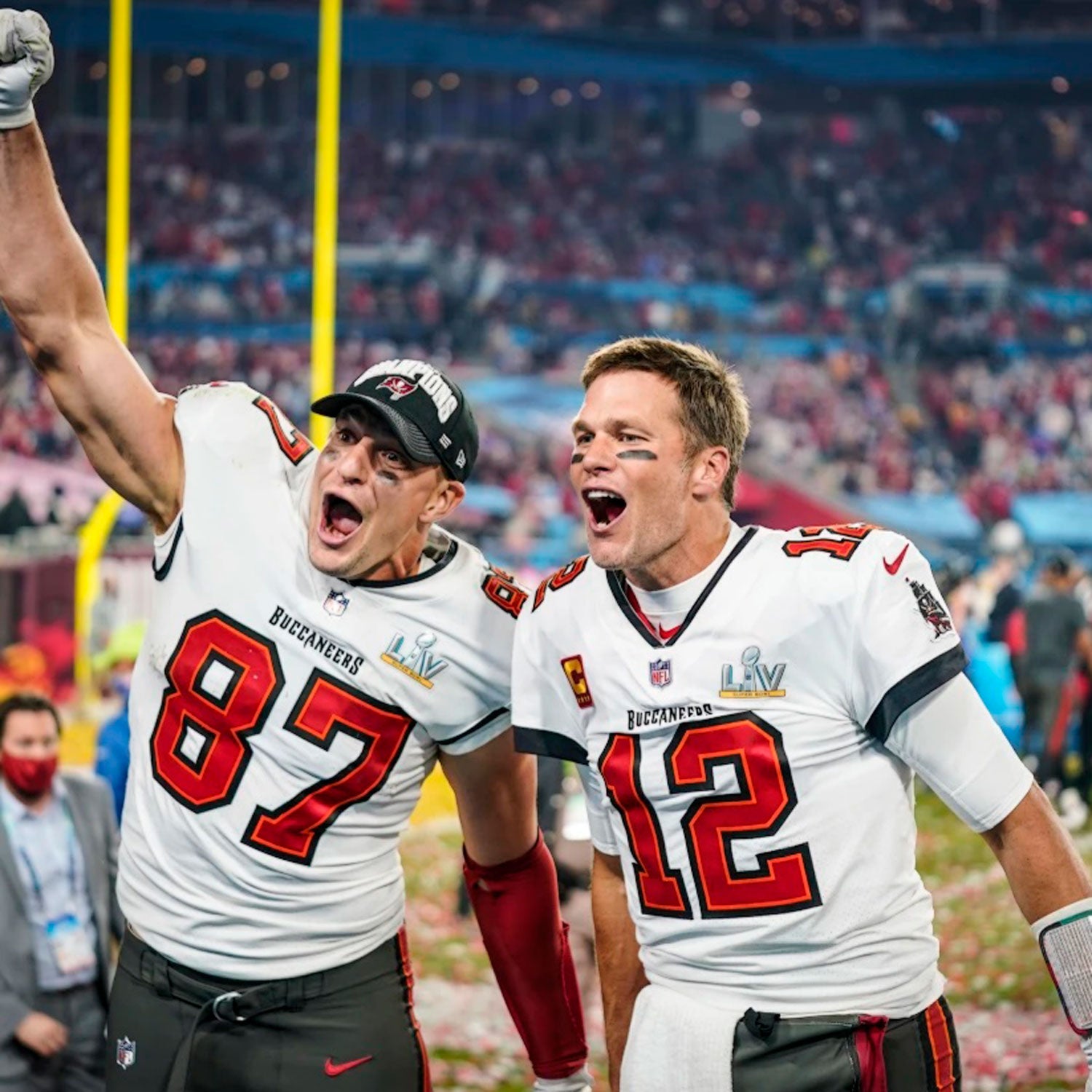An image of Rob Gronkowski and Tom Brady in Tampa Bay Buccaneer jerseys celebrating a win.