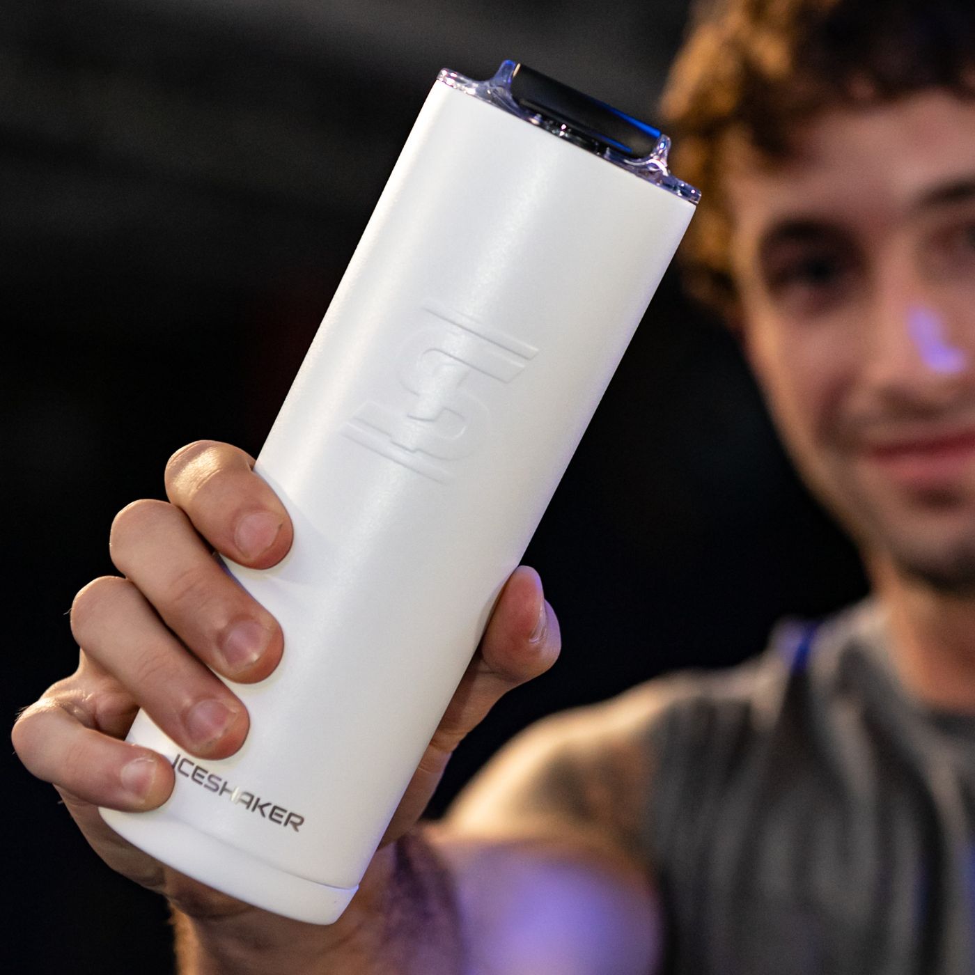 An image of a young man holding a white 20oz Skinny Tumbler. The slim design makes this cup very easy to hold