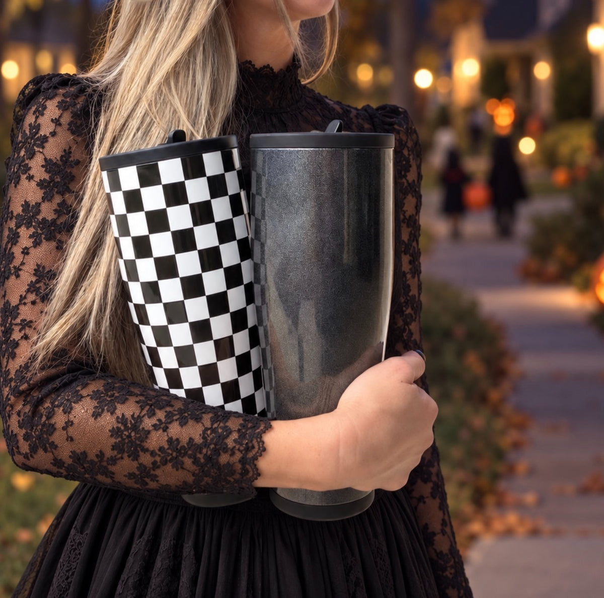 Both Halloween Legend Tumblers on a candlelit walkway