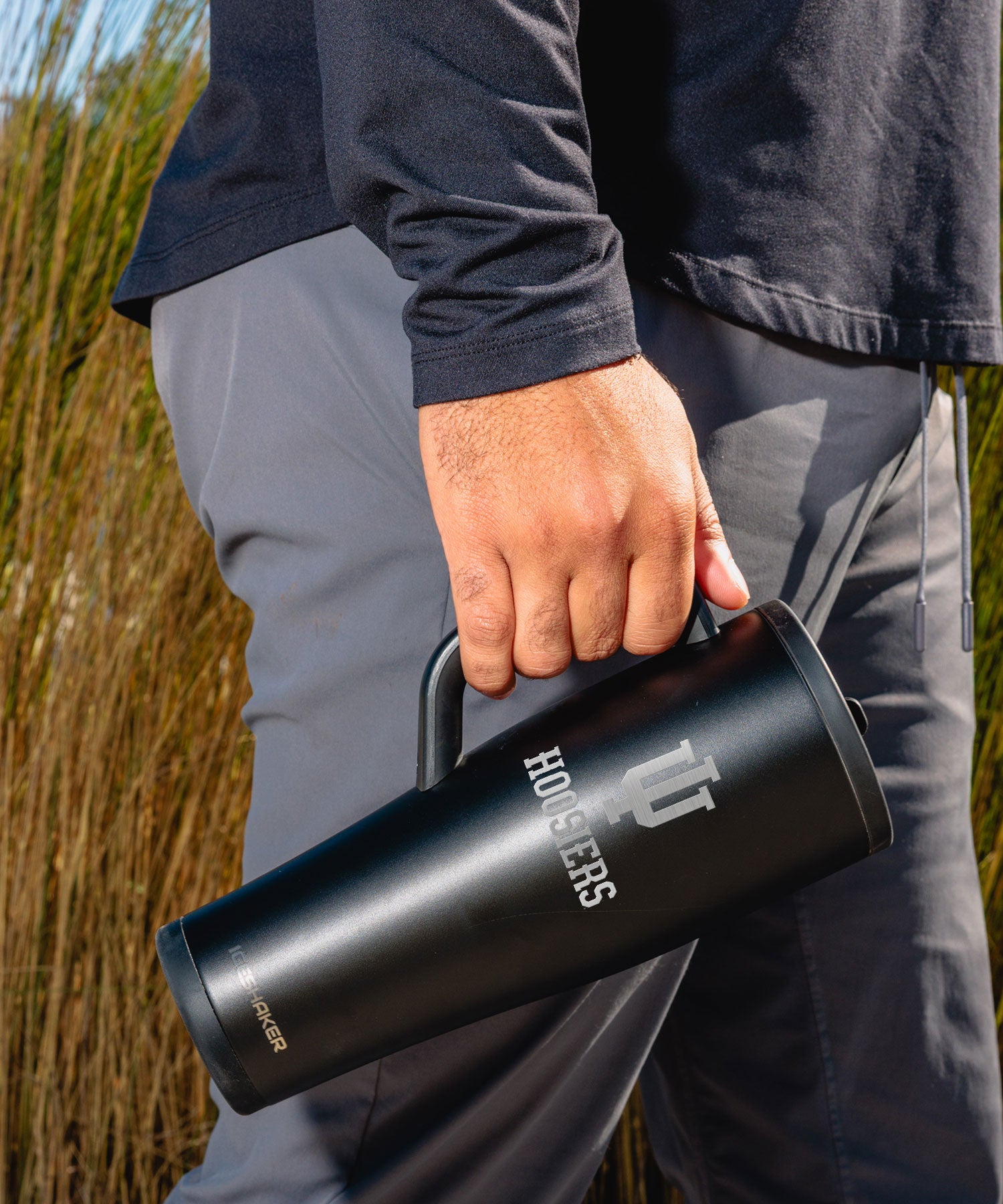 Person holding a black Indiana Hoosiers 40oz Legend Shaker Tumbler by its soft-grip handle.