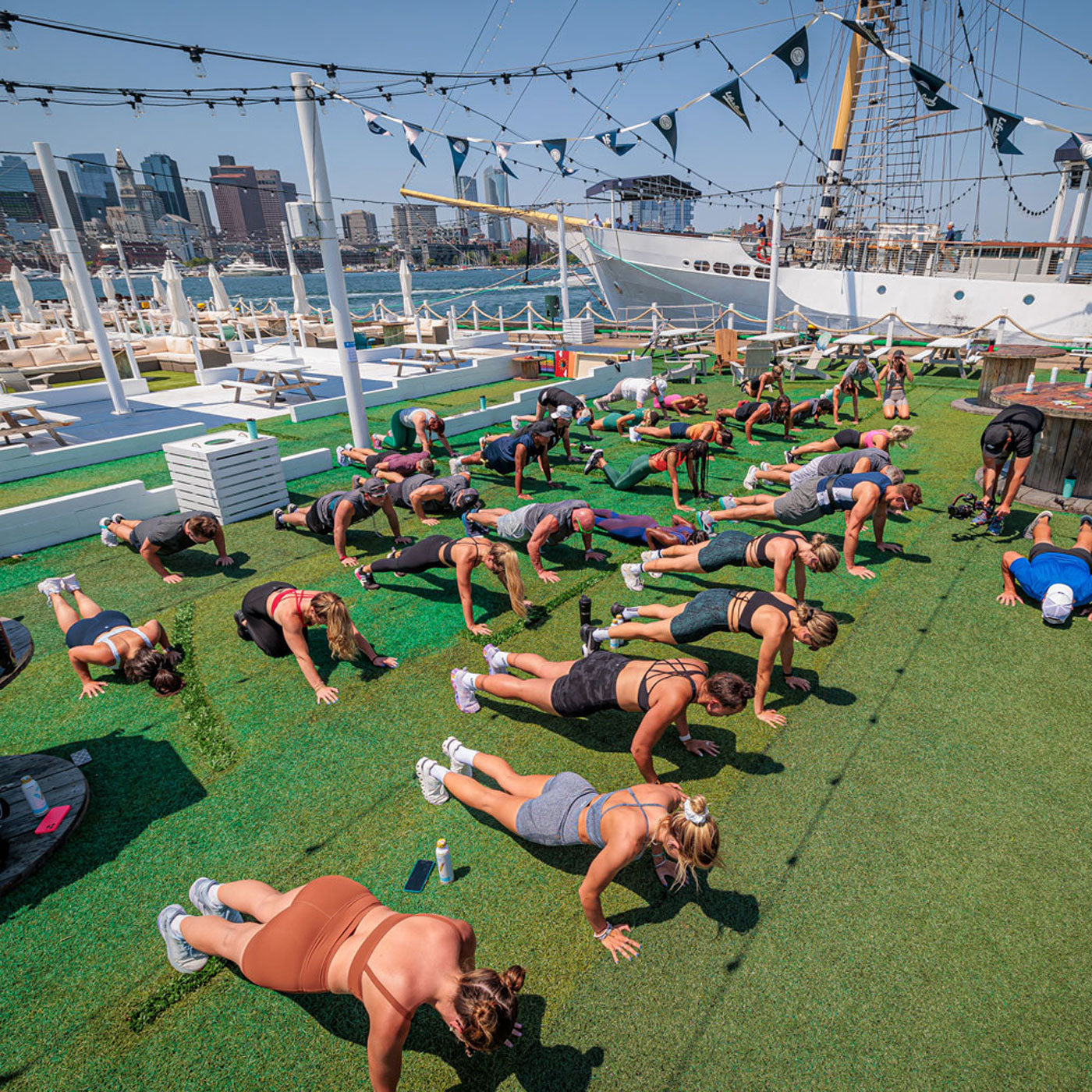 a picture of a group of people doing push ups in a large outdoor area
